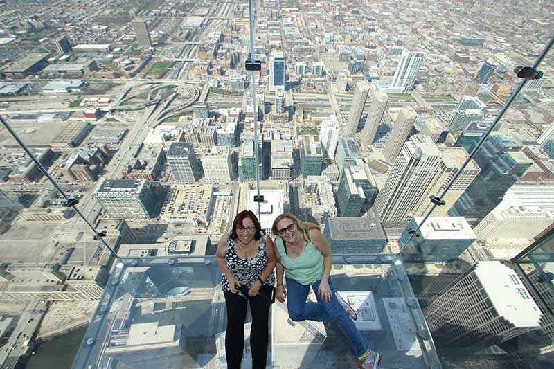 Standing on the ledge at The Skydeck at Willis Tower: