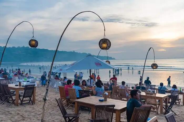 Where to spend the night in Bali for a peaceful tropical vacation and seafood is Jimbaran.